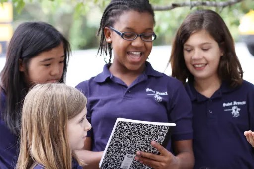 Students working together on an assignment outdoors