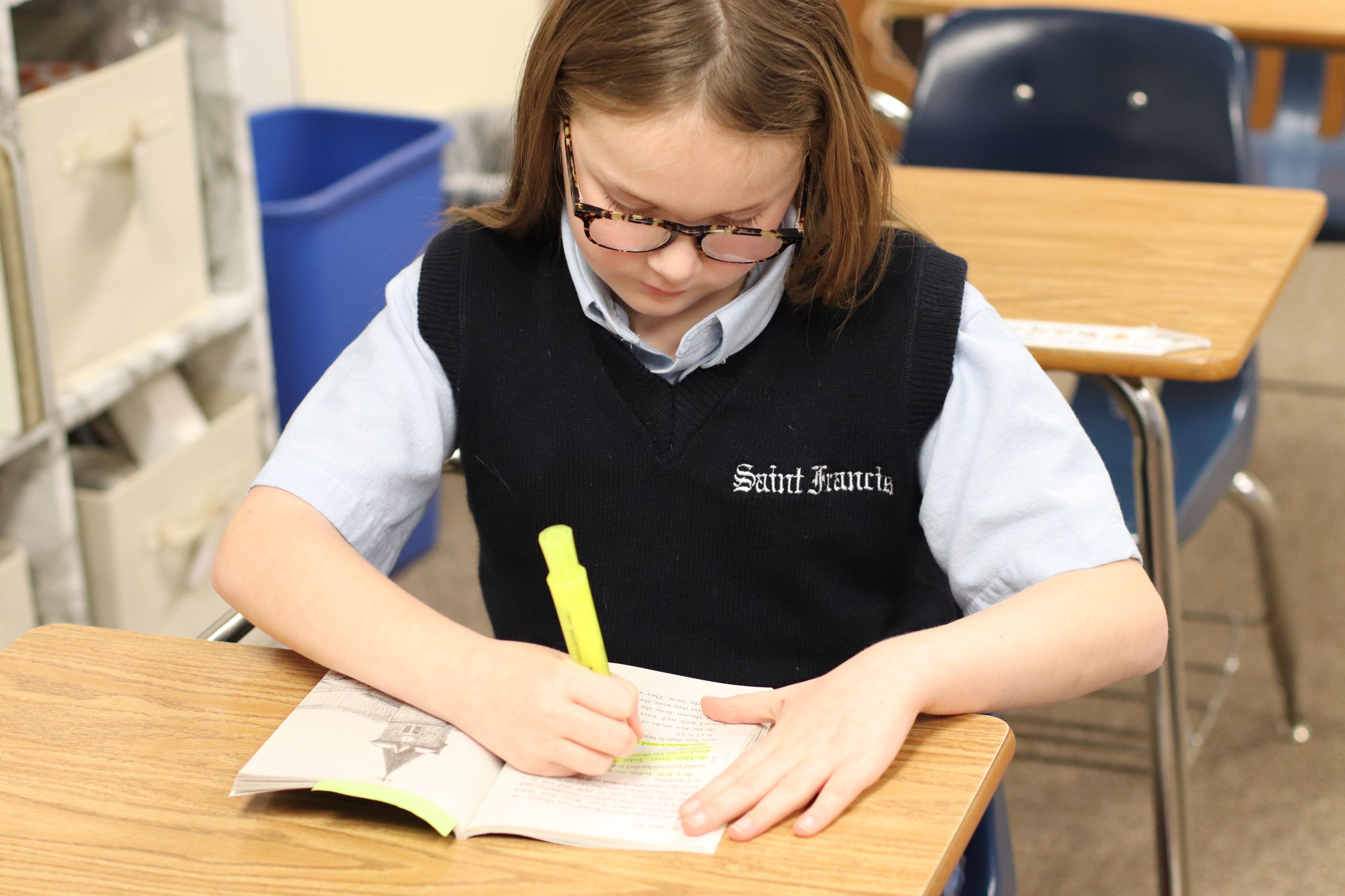 Saint Francis Middle School student highlighting important concepts from her assignment
