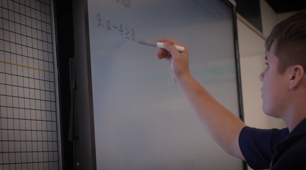 Student getting individualized attention in a small class for help with math