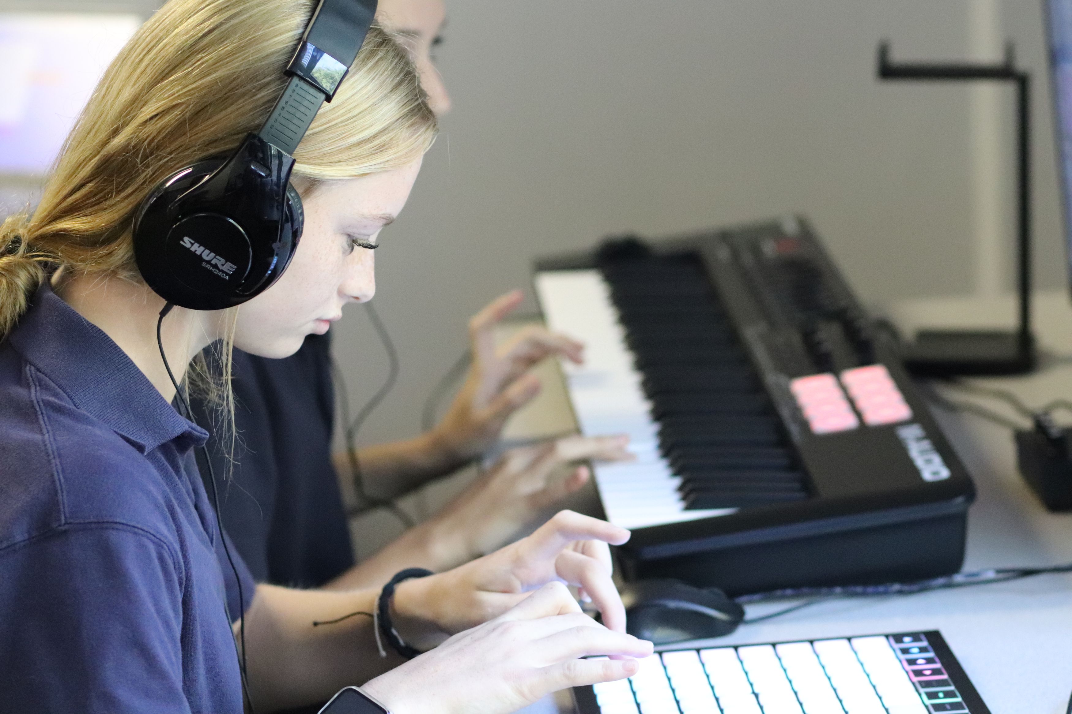Student using media center music studio equipment
